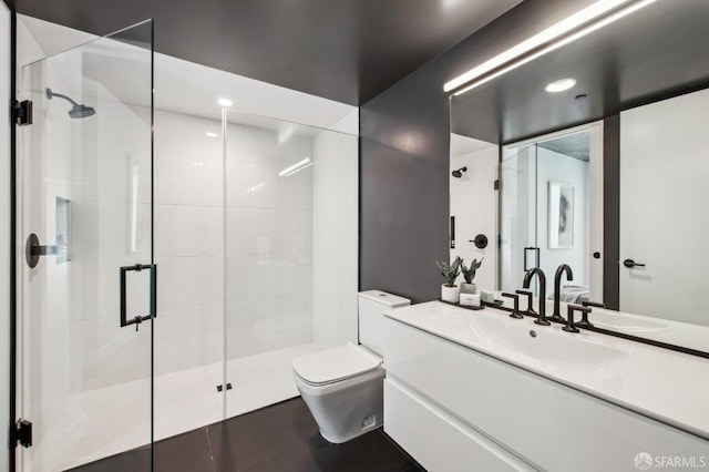 bathroom featuring tile patterned floors, vanity, toilet, and a shower with shower door