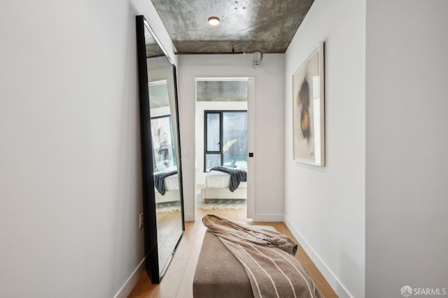 hallway with hardwood / wood-style floors