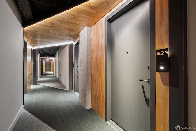 corridor featuring carpet floors and wood ceiling