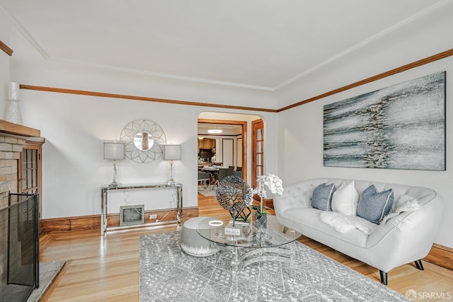 2375 31st Ave, San Francisco, CA 94116 - living area featuring arched walkways, baseboards, a fireplace, and wood finished floors