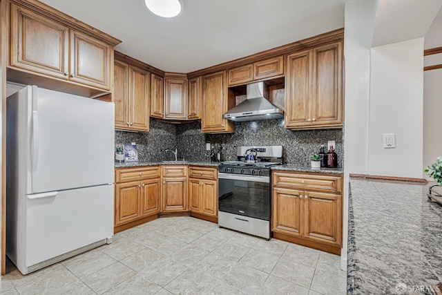 2375 31st Ave, San Francisco, CA 94116 - kitchen with stainless steel gas range oven, wall chimney exhaust hood, freestanding refrigerator, stone counters, and backsplash
