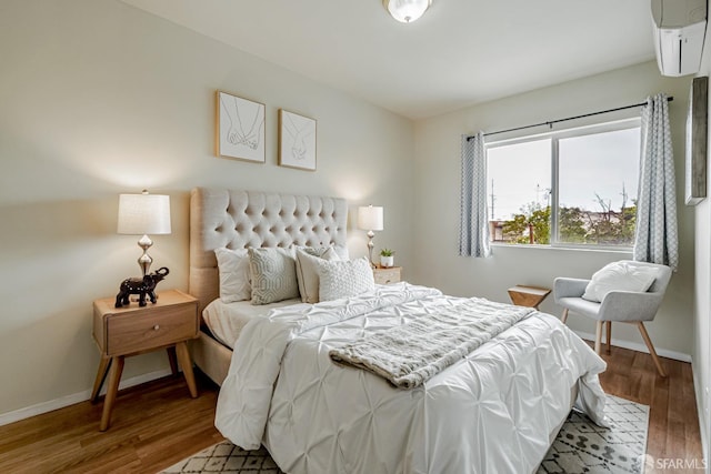 2375 31st Ave, San Francisco, CA 94116 - bedroom with baseboards, a wall mounted air conditioner, and wood finished floors