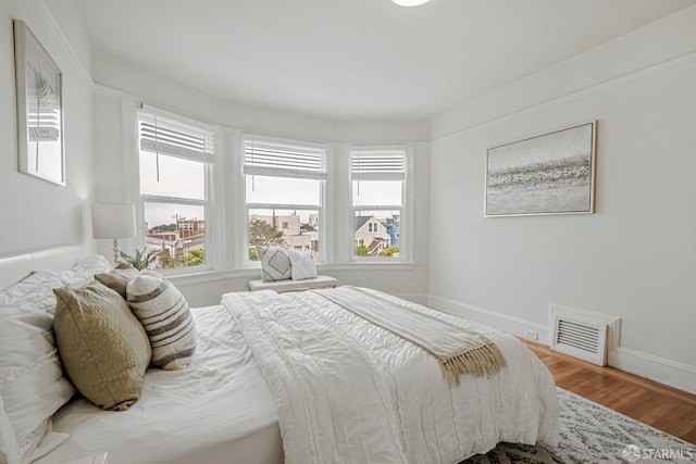 2375 31st Ave, San Francisco, CA 94116 - bedroom with baseboards, wood finished floors, and visible vents