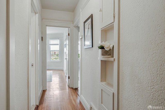 2375 31st Ave, San Francisco, CA 94116 - corridor featuring baseboards, light wood-style flooring, and a textured wall