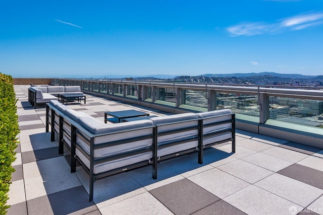 view of patio / terrace featuring a balcony, a mountain view, and an outdoor hangout area