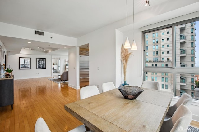 dining space with wood-type flooring