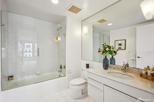 full bathroom with tile patterned flooring, enclosed tub / shower combo, vanity, and toilet