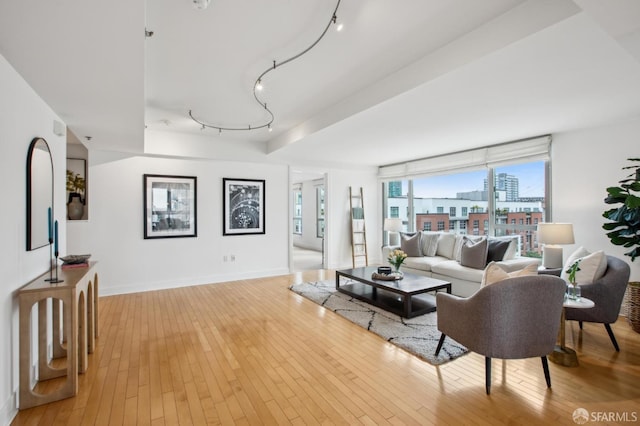 living room with track lighting and light wood-type flooring