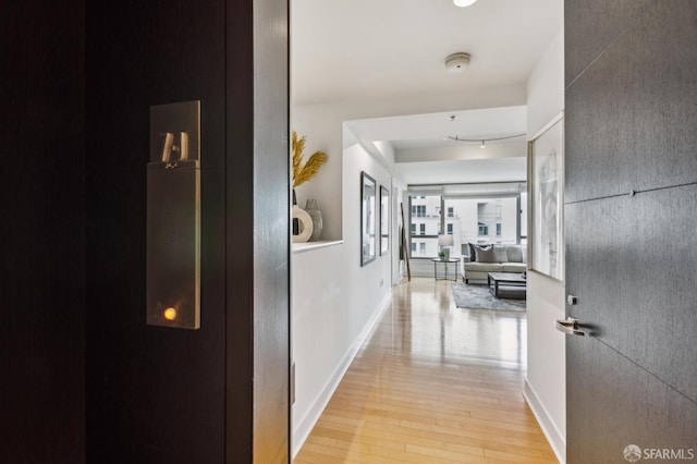 hallway featuring track lighting and light wood-type flooring