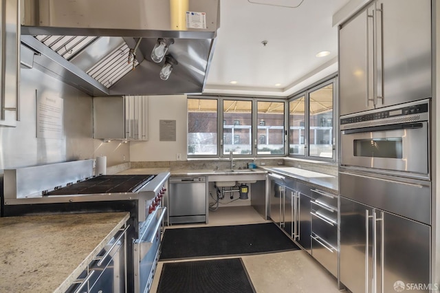 kitchen with extractor fan, stainless steel appliances, light stone countertops, and sink