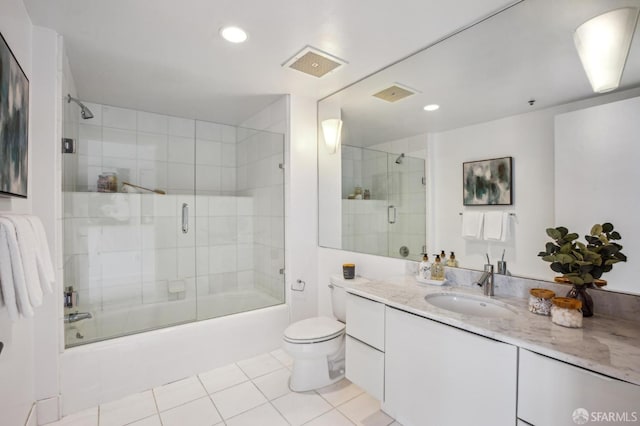 full bathroom featuring enclosed tub / shower combo, vanity, tile patterned flooring, and toilet