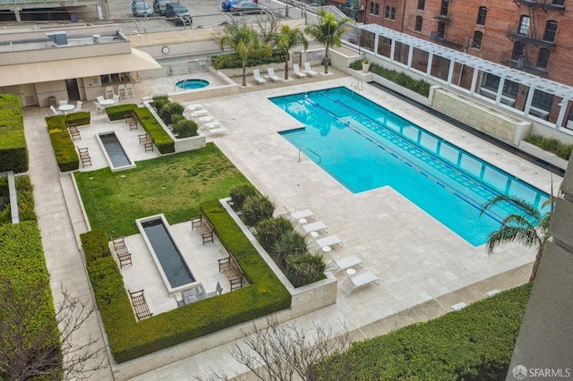 view of pool featuring a yard and a patio area