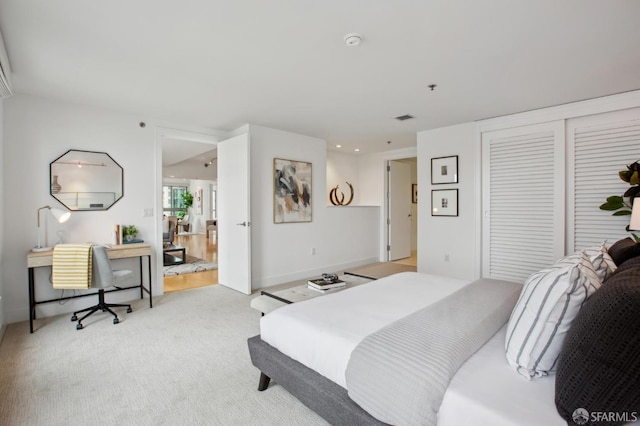 bedroom with a closet and light carpet