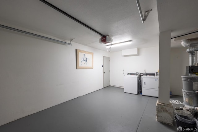 garage featuring washing machine and clothes dryer and a garage door opener