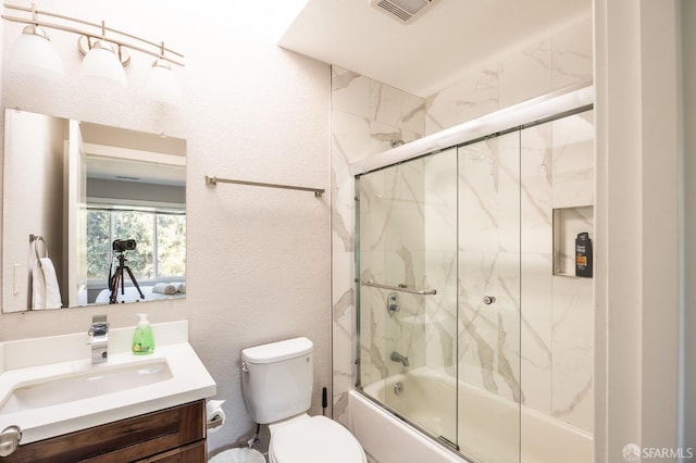 bathroom with enclosed tub / shower combo, a textured wall, toilet, vanity, and visible vents