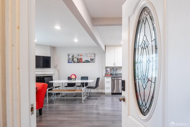 foyer entrance with a fireplace, baseboards, wood finished floors, and recessed lighting