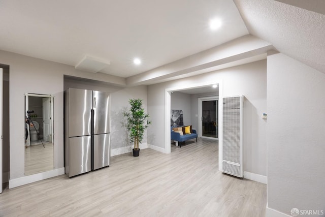 kitchen featuring light wood-style flooring, recessed lighting, baseboards, freestanding refrigerator, and a heating unit