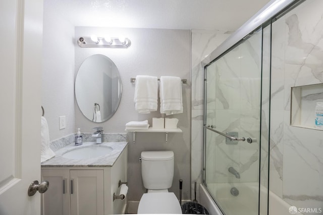 bathroom featuring enclosed tub / shower combo, vanity, and toilet