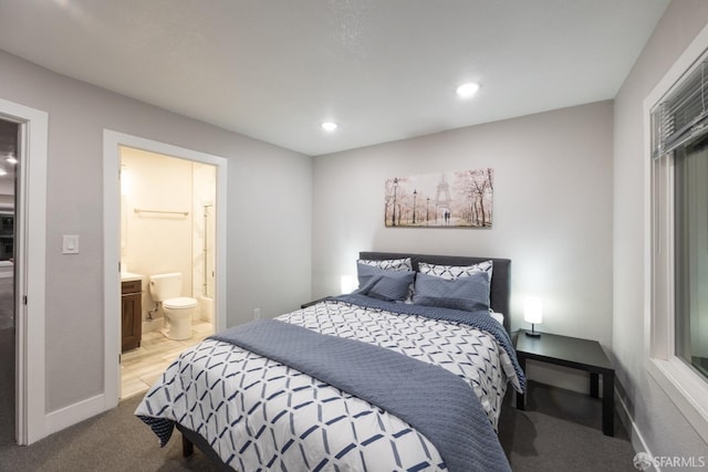 bedroom featuring recessed lighting, light carpet, connected bathroom, and baseboards