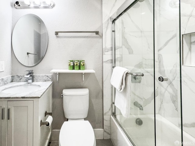 full bathroom featuring enclosed tub / shower combo, vanity, and toilet