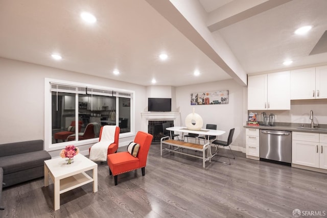 living room with wet bar, a fireplace, and wood finished floors