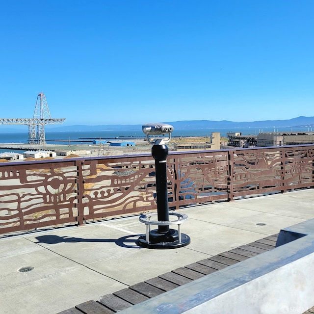 view of patio with a water and mountain view