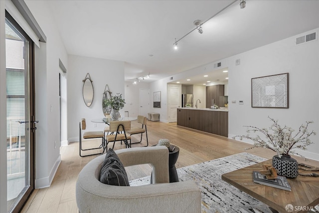 1080 Sutter St Unit 202, San Francisco, CA 94109 - living room featuring light wood-type flooring, track lighting, and sink