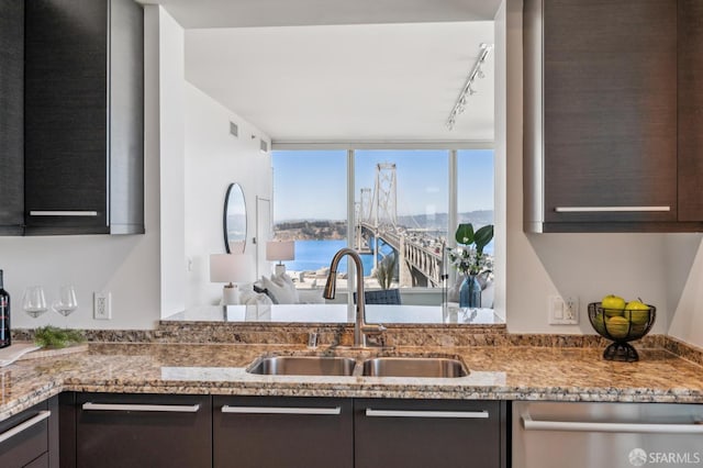 425 1st St Unit 1402, San Francisco, CA 94105 - kitchen featuring dishwasher, rail lighting, dark brown cabinets, and light stone countertops