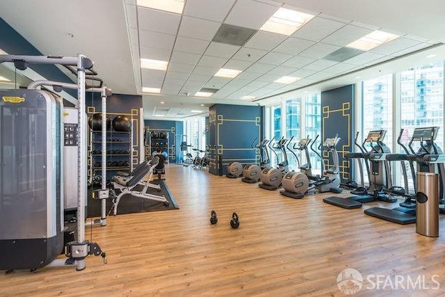 425 1st St Unit 1402, San Francisco, CA 94105 - exercise room featuring wood finished floors, a wall of windows, and a paneled ceiling