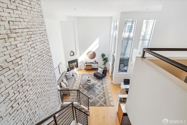 living room with a large fireplace and hardwood / wood-style flooring