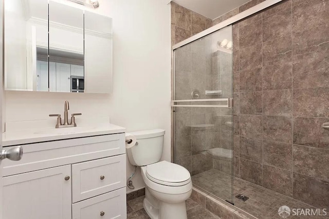 bathroom with a stall shower, tile patterned flooring, vanity, and toilet