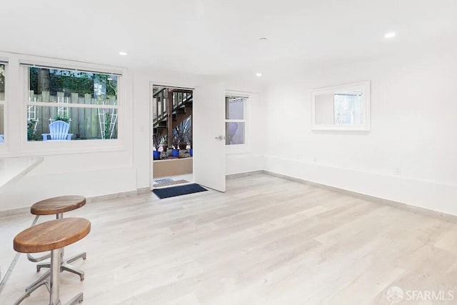 empty room featuring baseboards, wood finished floors, and recessed lighting