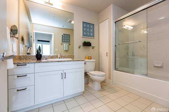 full bathroom featuring vanity, combined bath / shower with glass door, tile patterned flooring, and toilet