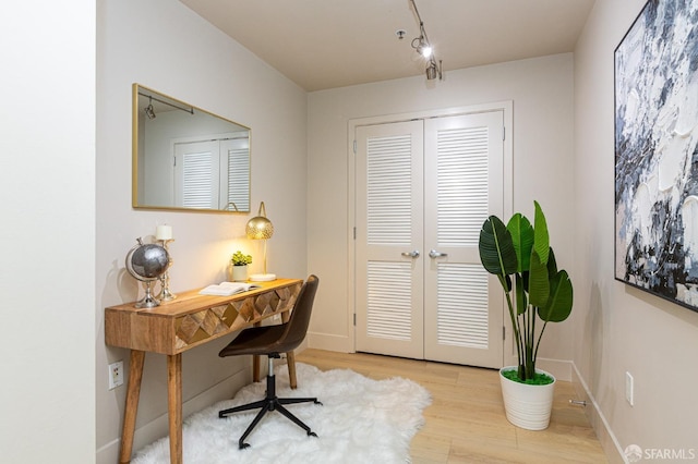 office featuring french doors, baseboards, and wood finished floors