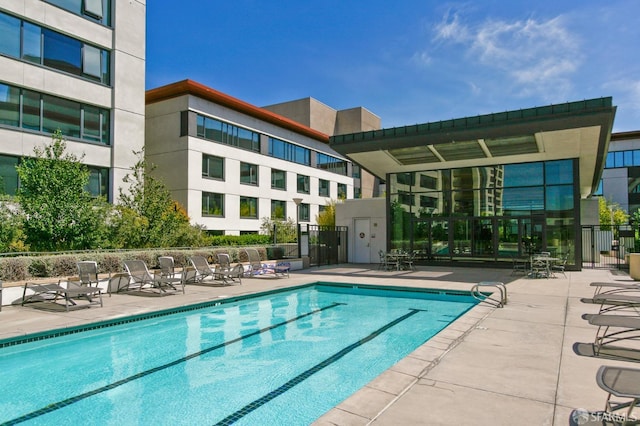 view of pool featuring a patio area and fence