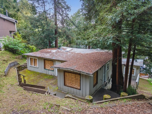 exterior space featuring board and batten siding and fence