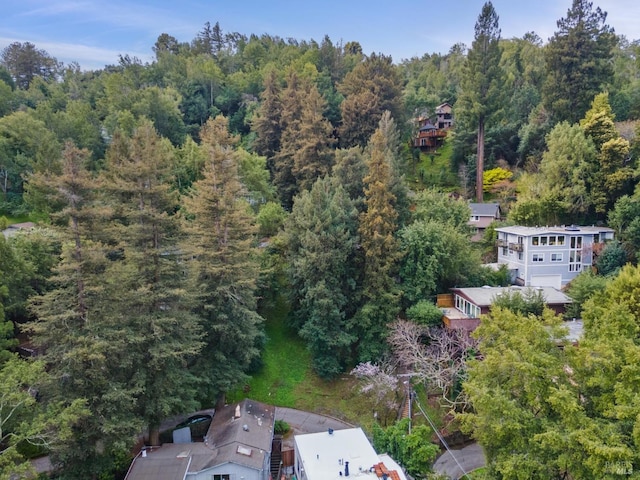 drone / aerial view with a wooded view