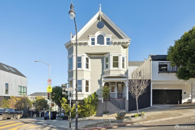 victorian-style house featuring a garage