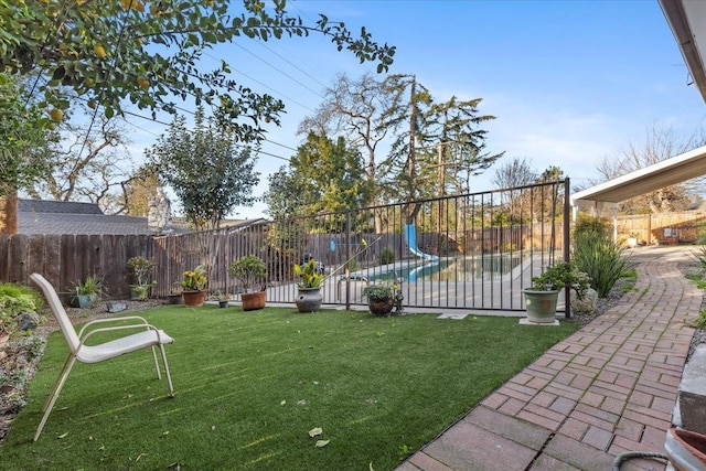 view of yard featuring a fenced in pool and a patio area