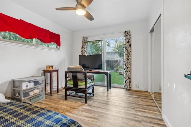 bedroom with hardwood / wood-style flooring, a closet, and ceiling fan