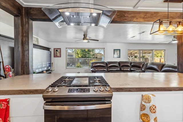 kitchen featuring decorative light fixtures, a healthy amount of sunlight, ceiling fan, and gas stove