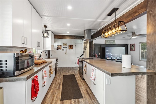 kitchen featuring decorative light fixtures, white cabinetry, and appliances with stainless steel finishes