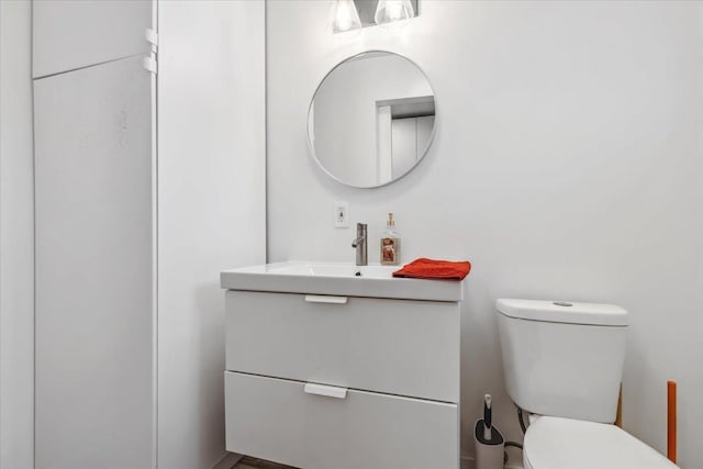 bathroom with toilet and vanity