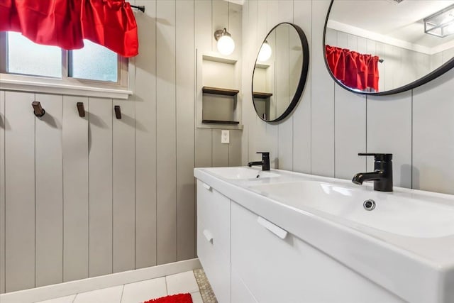 bathroom featuring wood walls, tile patterned flooring, and vanity