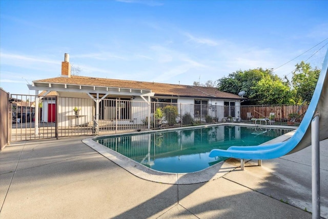 view of pool featuring a patio and a water slide