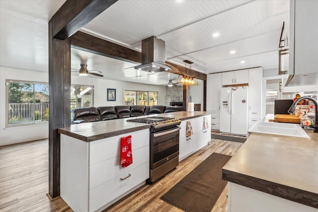 kitchen with white refrigerator with ice dispenser, stainless steel range with gas cooktop, white cabinetry, light hardwood / wood-style floors, and island range hood