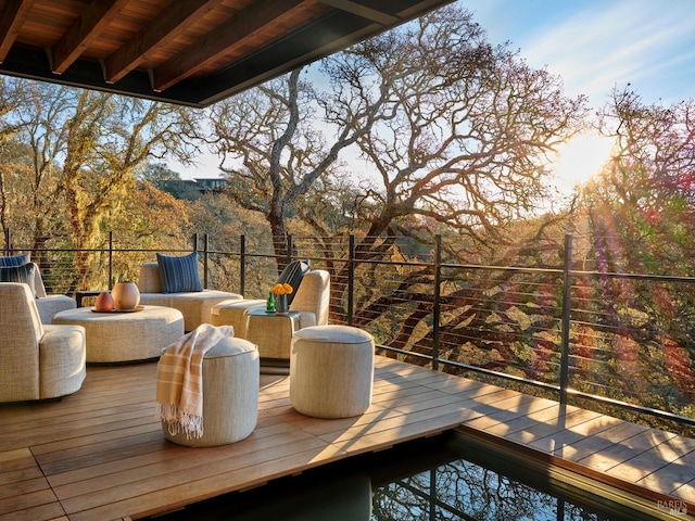 wooden terrace with an outdoor living space