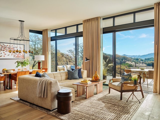 interior space featuring an inviting chandelier, plenty of natural light, and a mountain view