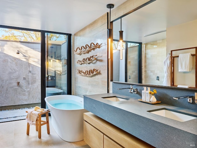 bathroom with walk in shower, vanity, and tile walls