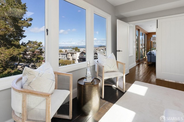 sitting room with hardwood / wood-style floors and baseboards